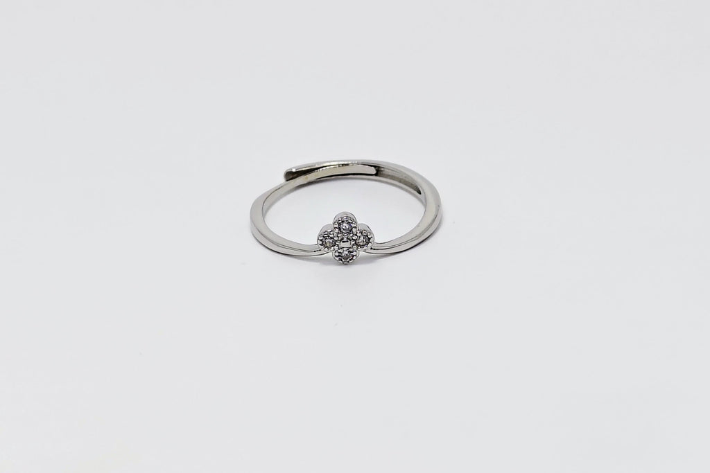 Silver ring with a small decorative element on a white background