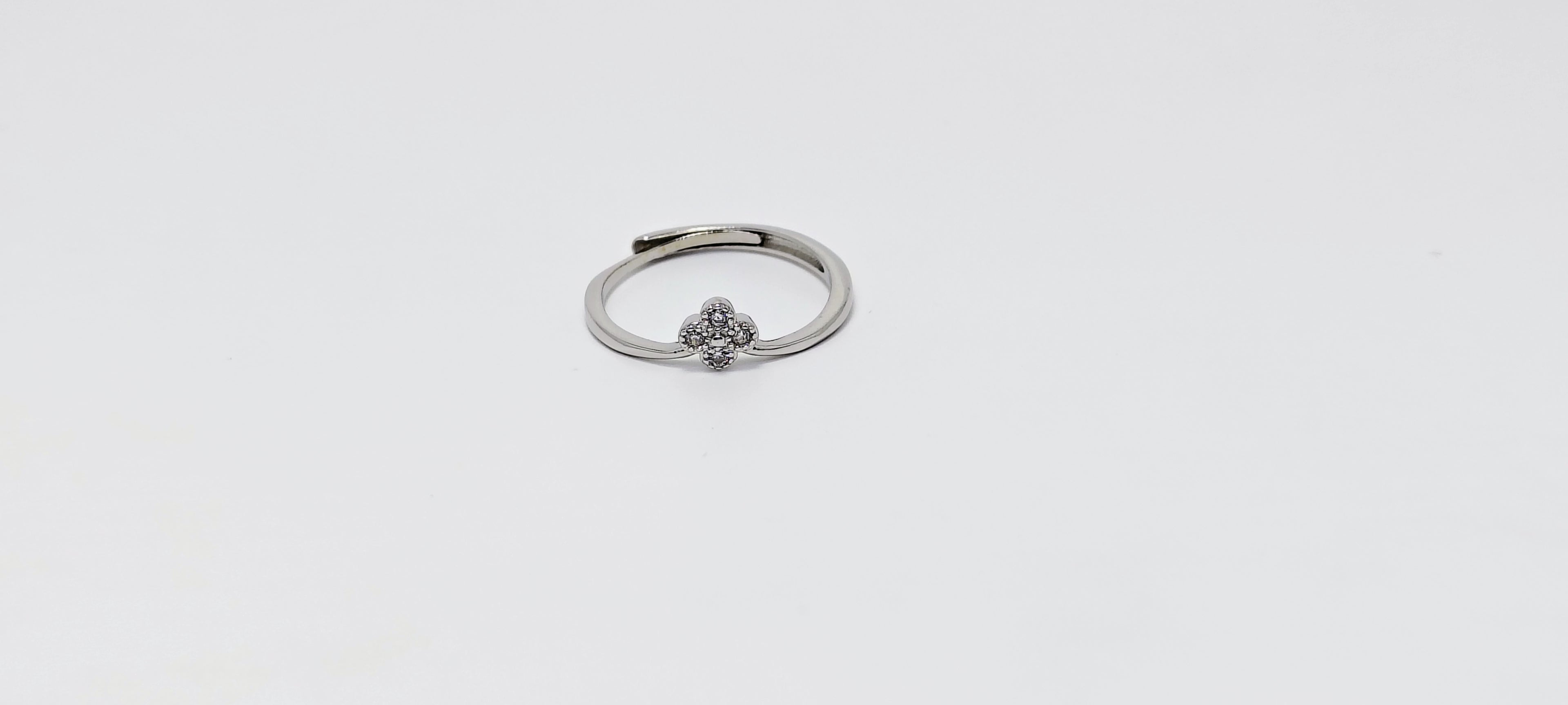 Silver ring with a small decorative element on a white background