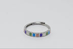 Silver ring with colorful square stones on a light gray background