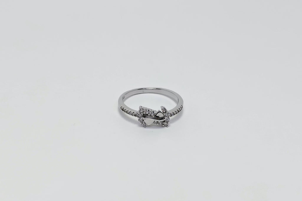 Silver ring with a small heart and star design 