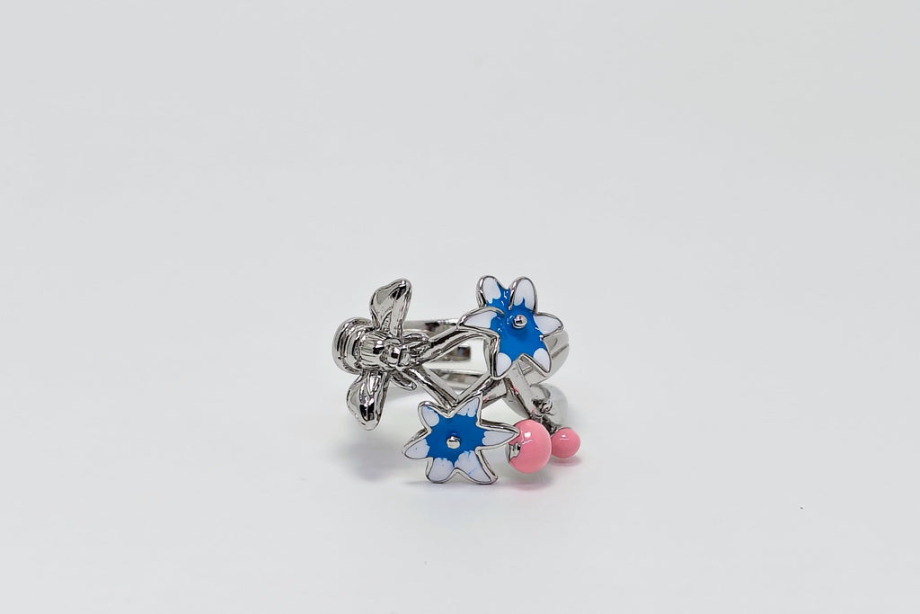 Silver earring with blue and pink accents on a white background