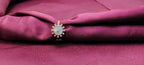 Decorative brooch on a maroon fabric background