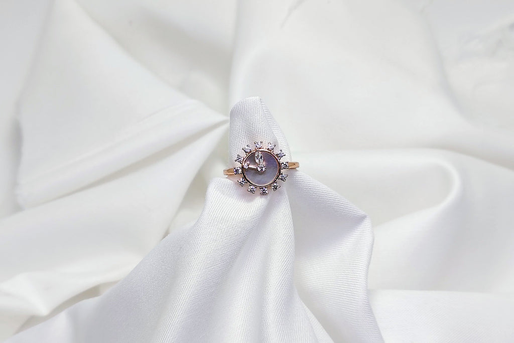 Ring with a central gemstone on a white fabric background