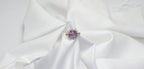 Ring with a central gemstone on a white fabric background