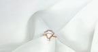Ring with a heart-shaped diamond on a white fabric background