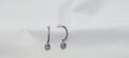 Pair of silver earrings with clear stones