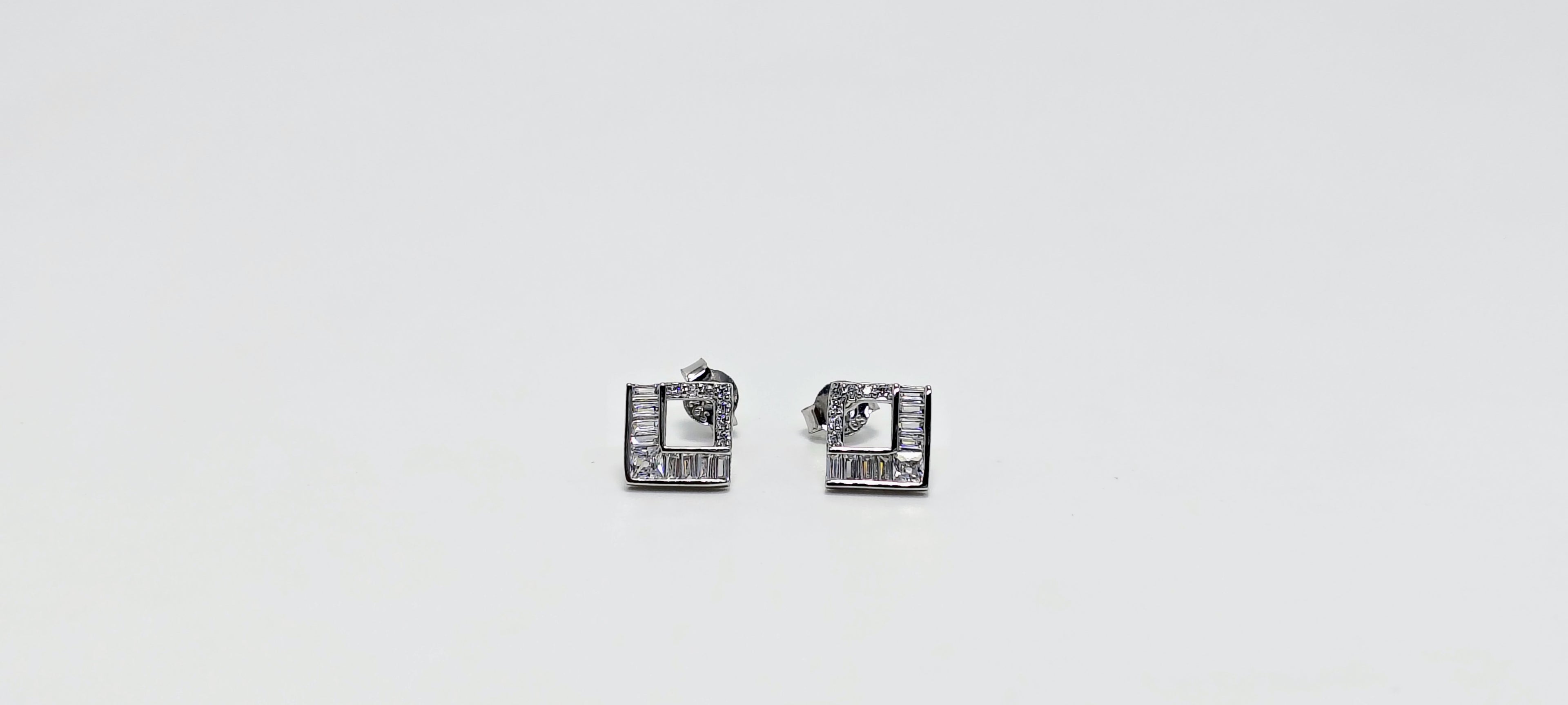 Pair of silver square earrings on a white background