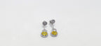 Pair of earrings with yellow gemstones on a white background