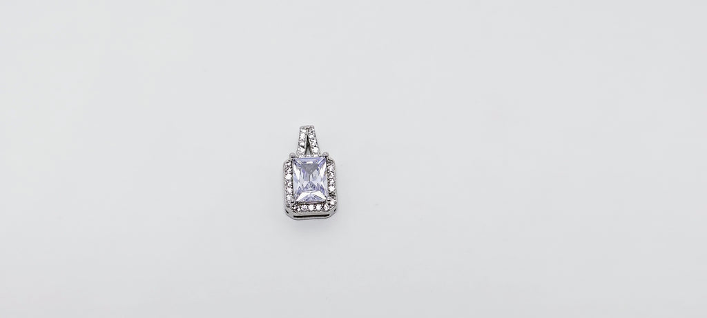 Silver pendant with a clear gemstone on a light gray background