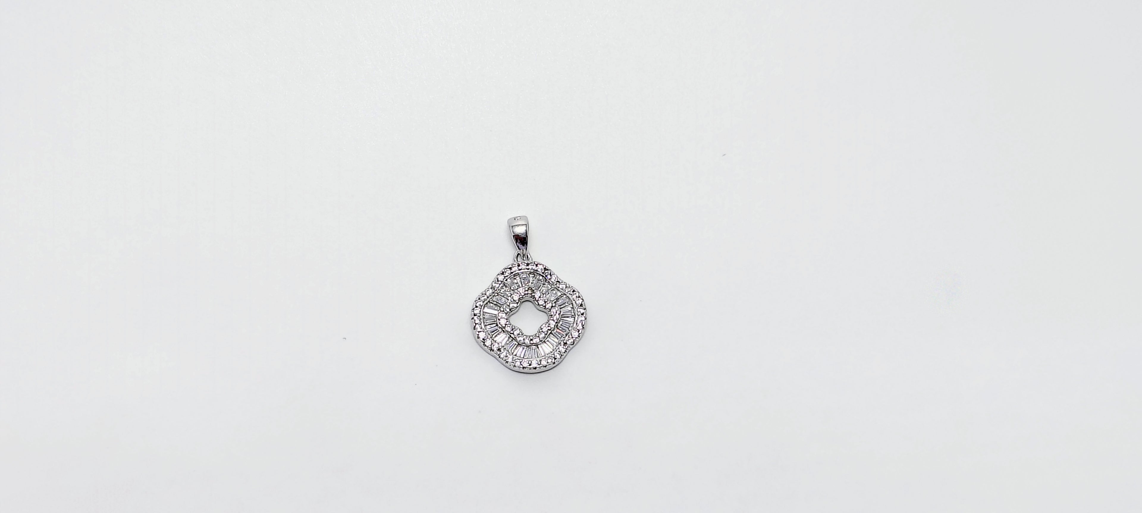 Silver pendant with intricate design 