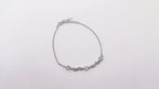 Silver bracelet on a light gray background