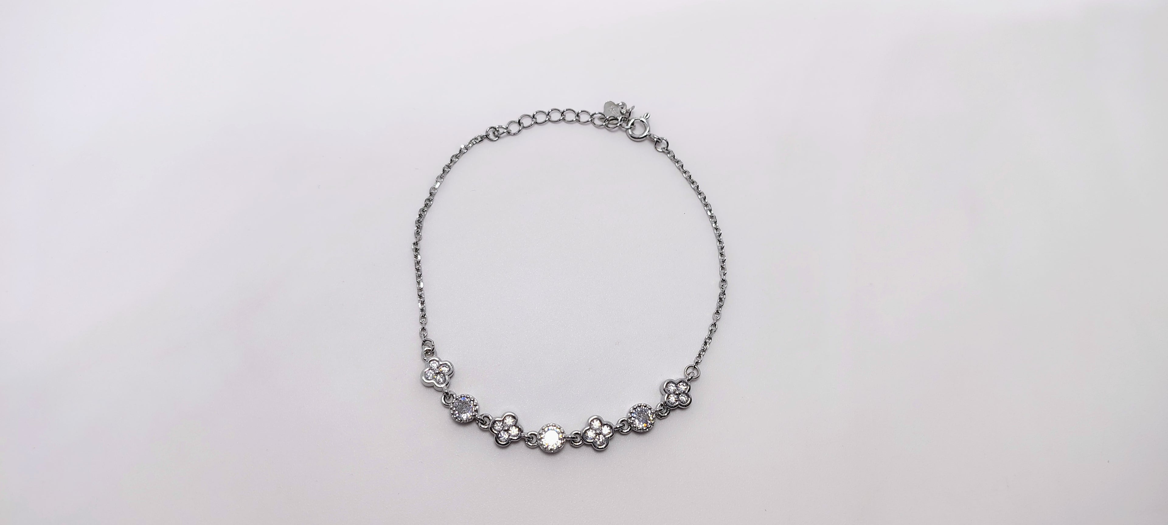 Silver necklace on a light gray background