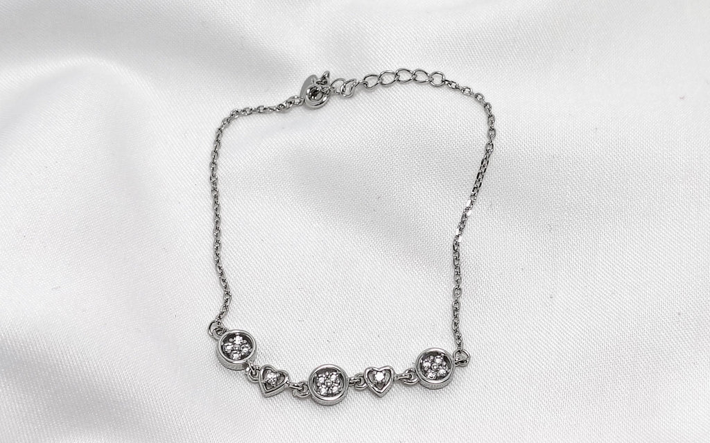 Silver bracelet on a white fabric background