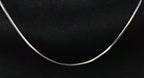 Silver necklace on a black background