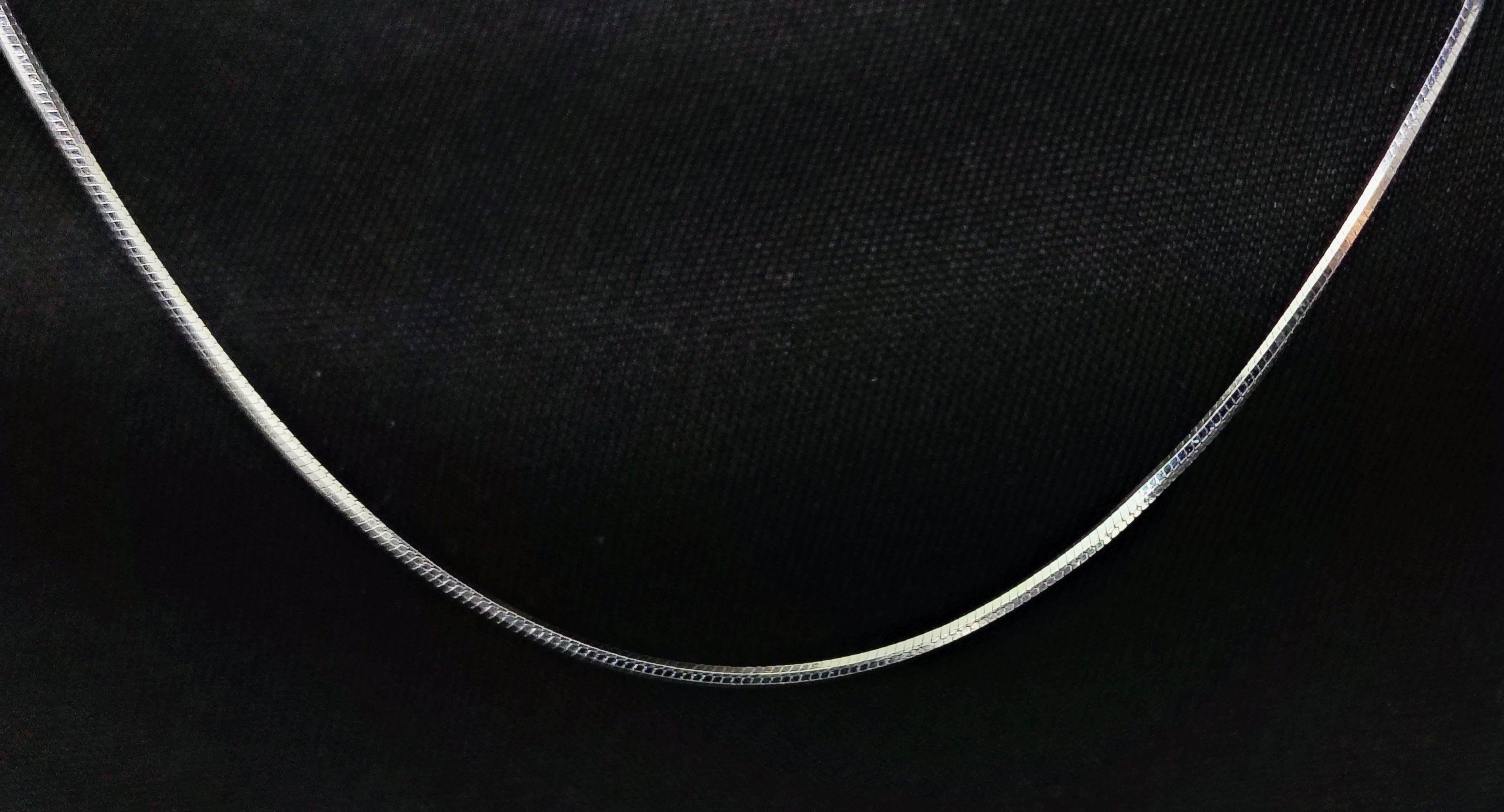 Silver necklace on a black background